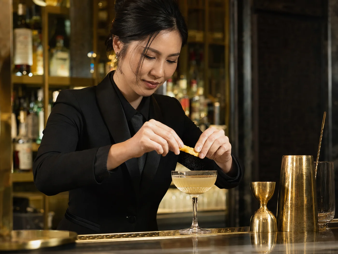 Bartender finishing a cocktail with care